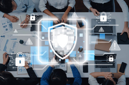 A group of professionals collaborates at a modern office table, focusing on cybersecurity strategy,...