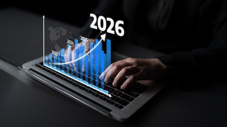 A business professional engages with financial data on a laptop, showcasing graphical growth...