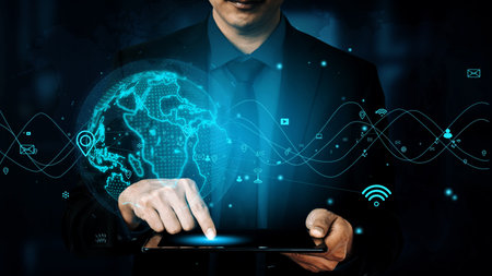 A businessman engages with a tablet, showcasing a digital interface that represents global...