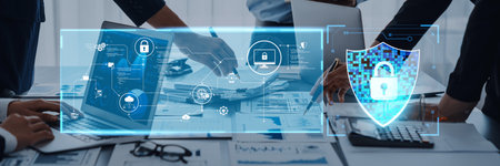 A business team collaborates on a cybersecurity plan in a modern office, utilizing technology and...