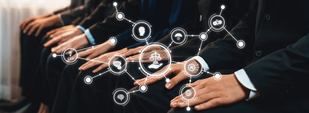 This image captures the hands of business individuals in suits, symbolizing ethical principles and legal concepts through a network of interconnected icons in a conference setting.の写真素材