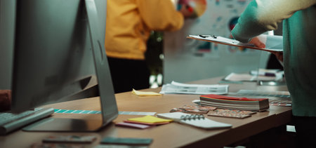 A dynamic business meeting takes place in a modern office setting, where diverse professionals...