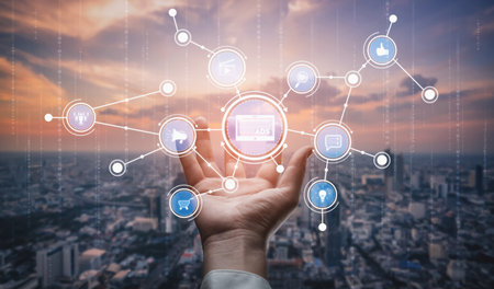A hand reaches out toward floating digital icons symbolizing social media and marketing, set against a stunning city skyline during sunset, showcasing technology interaction. Tesselの写真素材