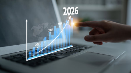 A close-up of a hand pointing at a graphical representation of business growth on a laptop screen,...