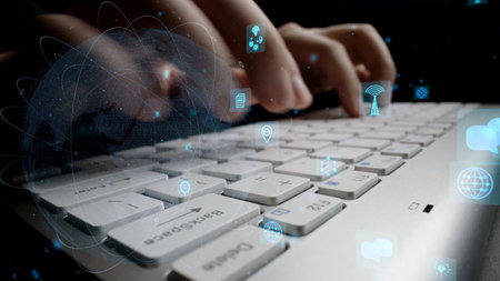 A close-up perspective of hands actively typing on a laptop keyboard, surrounded by floating digital...
