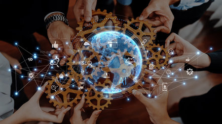 A diverse group of hands holds a gear mechanism around a digital globe, symbolizing innovation,...