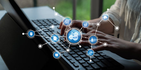 Close-up view of hands typing on a keyboard with digital icons representing key performance...