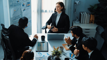 Top view of professional businesswoman pointing mind map and investment chart at whiteboard while...
