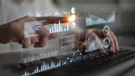 A focused individual analyzes data using a laptop, interacting with dynamic infographics that...