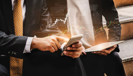 Two business professionals engaging with financial data on their mobile devices. This image conveys...