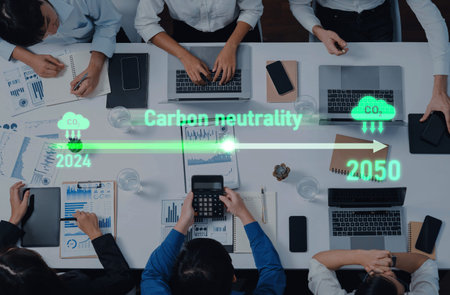 Group of diverse professionals engaged in a meeting focused on achieving carbon neutrality,...