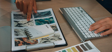 A dynamic creative workspace showcasing mood boards and color palettes. Professional hands engaging...