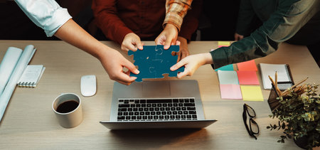 A diverse team actively collaborating during a brainstorming session, hands reaching for a puzzle...
