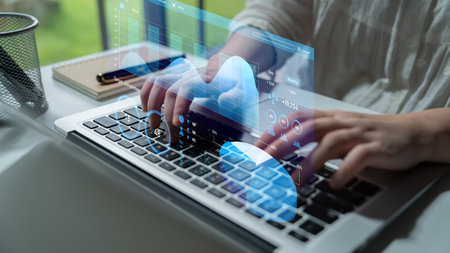 A person engages in typing on a laptop amid a high-tech digital interface, showcasing data and...