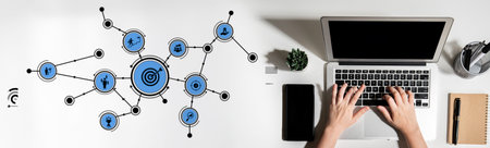 A modern workspace featuring a laptop with hands typing and a dynamic digital network graphic,...