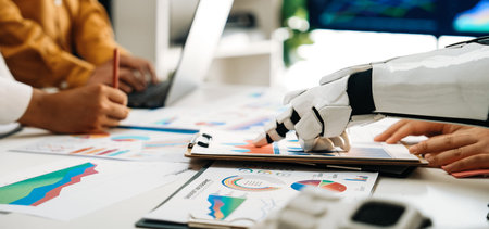 A robotic hand assists professionals in analyzing data and creating business strategies through...