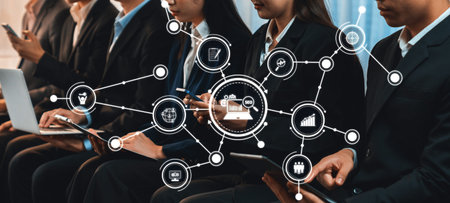 Professionals in a meeting, using various devices, engaged in discussion and data analysis while...