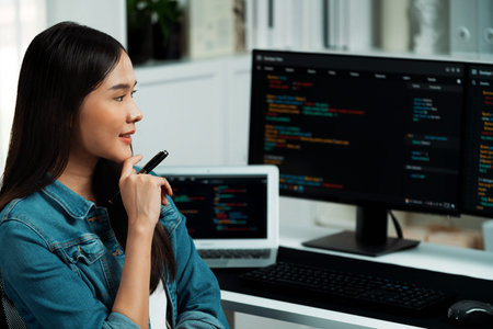 Young IT developer looking online information on pc with coding program data of website application,...