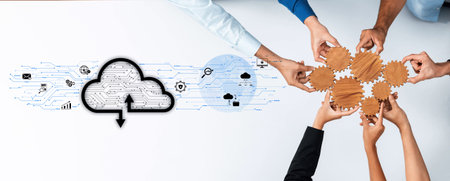 A group of diverse individuals collaborates in a modern workspace, illustrating teamwork and innovation with cloud technology and gears representing growth and strategy.の写真素材
