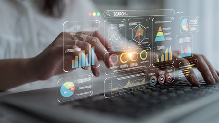 Hands Typing on Keyboard with Data Visualization and Graphs Illustrating Digital Analytics in Modern...