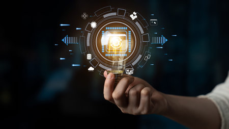 Hand Holding Light Bulb with Digital Icons Representing Technology Innovation and Smart Solutions in...
