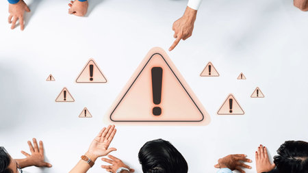 A diverse group of professionals engages in critical discussion around noticeable warning signs on a white table, emphasizing urgency and teamwork in problem-solving. Rasterの写真素材