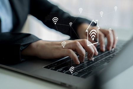 A professional man types on a laptop, highlighting the integration of smart home technology symbols, showcasing the blend of modern work and advanced connectivity. Gantryの写真素材