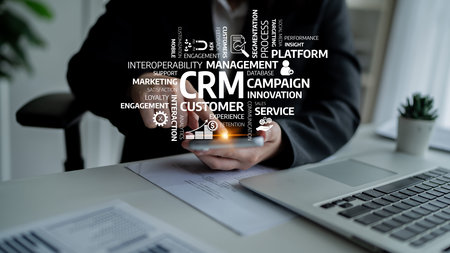 A business professional interacts with a smartphone while surrounded by CRM concepts, emphasizing modern customer management and innovative marketing strategies in a vibrant office environment. Tesselの写真素材