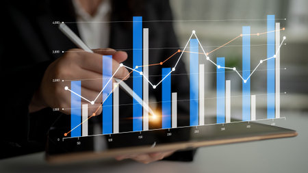 Modern business analysis showcasing digital graphs and growth indicators on a tablet, emphasizing...