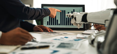 A business team engages in a meeting, analyzing data presented on a digital screen, highlighting...