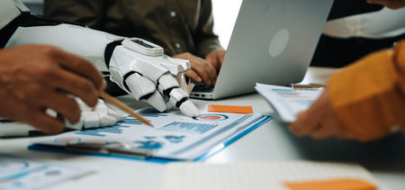 A human and a robot collaborate in a modern office setting, analyzing data and discussing...