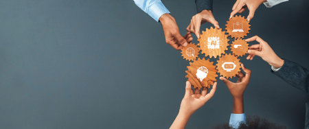 Hands from diverse individuals connect wooden gears, representing collaboration and innovation in a...