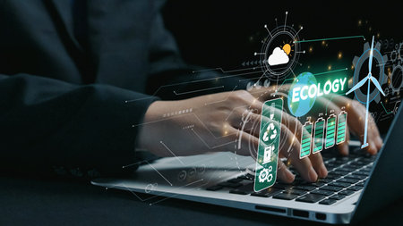 A business professional interacts with a laptop displaying digital ecology symbols, emphasizing...