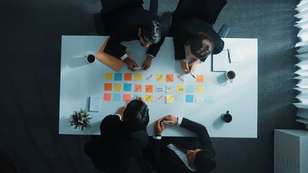 Top view of professional business people working on sticky notes. Project manager writing marketing...