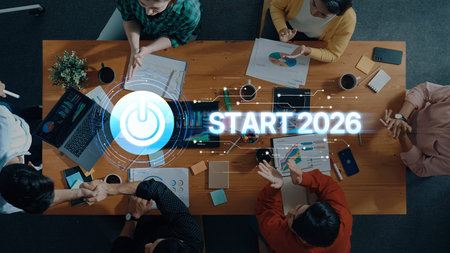 A diverse team engages in a strategy meeting, utilizing technology and digital graphics to plan for...