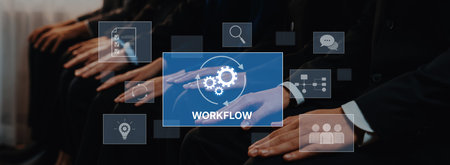 A group of business professionals is engaged in a digital session focused on workflow management,...