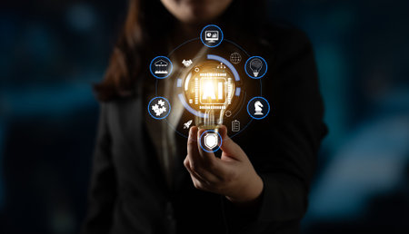 Business person holding light bulb icon in hand, symbolizing innovation, technology, and digital...