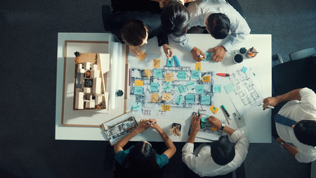 Top aerial view of project manager or civil engineer writing at blueprint and planning building...