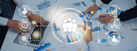 Business teamwork connected around a globe representing cooperation, leadership, and organizational...