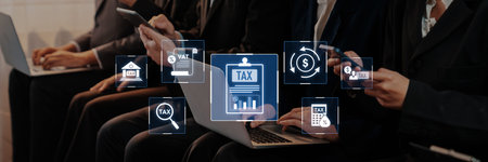 A diverse group of business professionals collaborates on tax preparation using laptops and mobile...