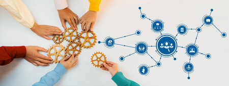 Hands unite to assemble gears, symbolizing teamwork and collaboration in a modern workspace. Digital...