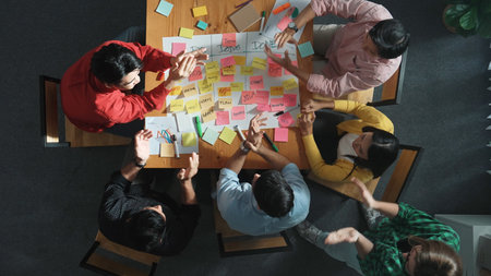 Top view of people writing and making scrum task board or kanban board while writing plan and...