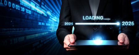A businessman holds a tablet displaying a loading bar for the new year 2026, symbolizing progress...