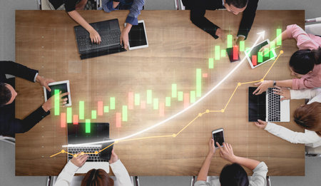 A modern business meeting showcasing teamwork and technology, featuring laptops and devices on a...
