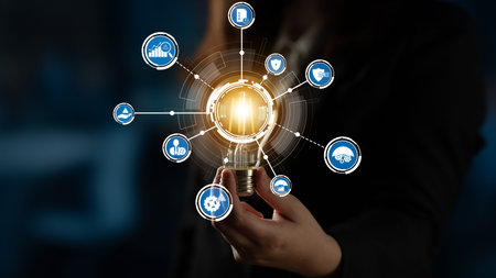 A business professional holds a glowing light bulb, symbolizing innovation and technology, with...