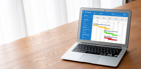 Project planning software for modish business project management on the computer screen showing timeline chart of the team projectの写真素材