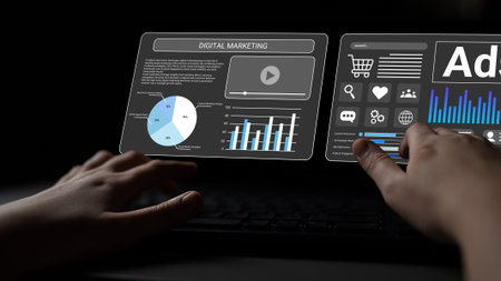 A close-up view of hands using a futuristic touchscreen display featuring digital marketing data and...