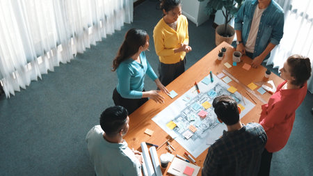 Top view of smart civil engineer team shaking hand while discussing idea at meeting table with...