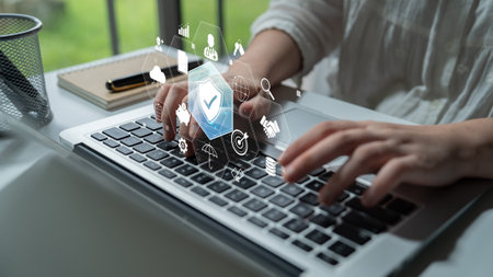 Person Typing on Laptop with Digital Icons Representing Technology, Innovation, and Data Analysis in...