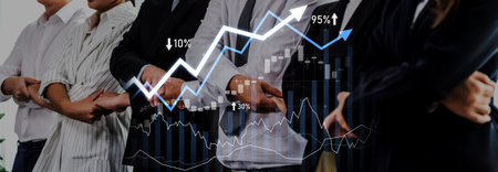 A professional group of business individuals stands confidently together, showcasing stock market...